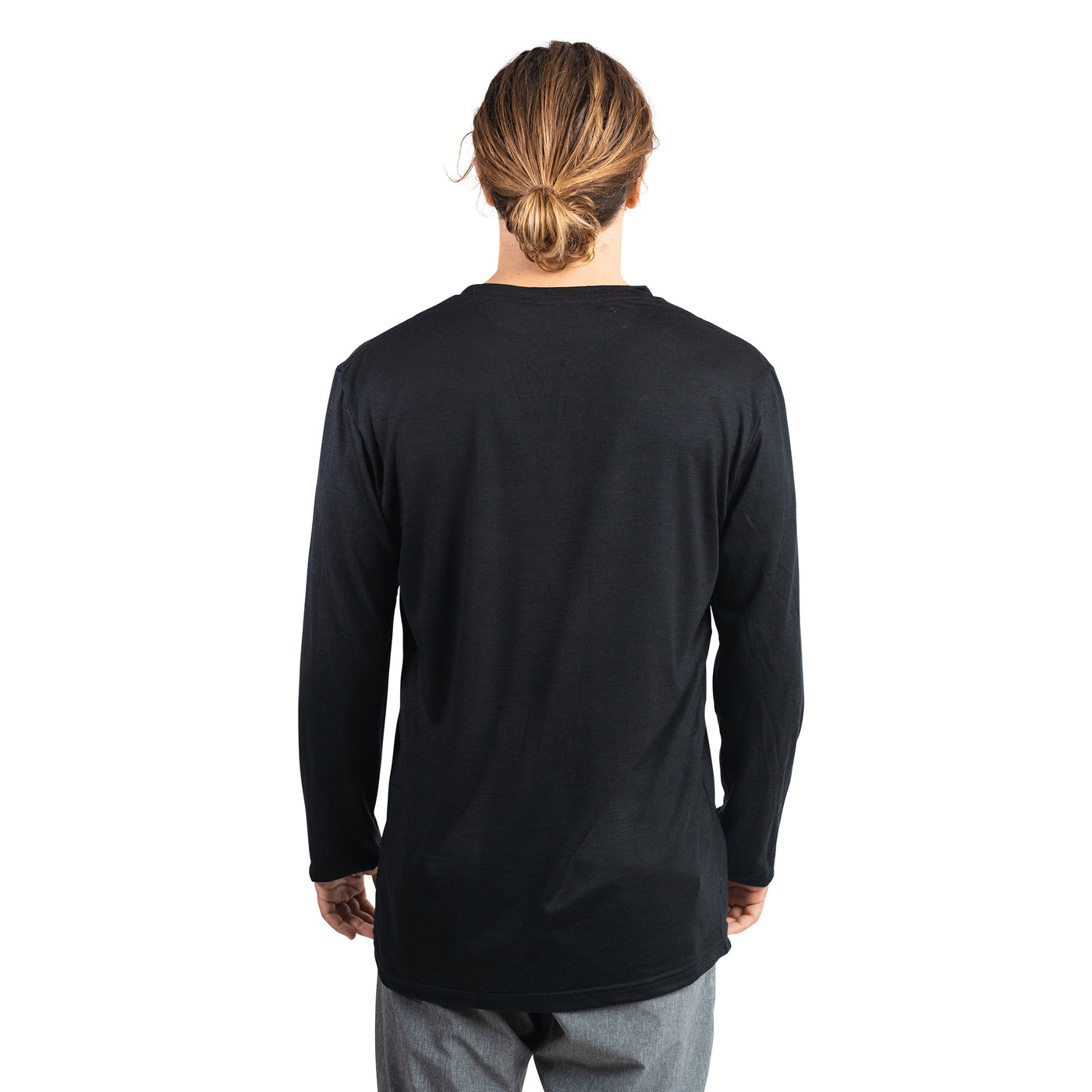 Back shot of Ottie Merino men's black long sleeve merino wool t-shirt on 173cm model who is wearing a size medium