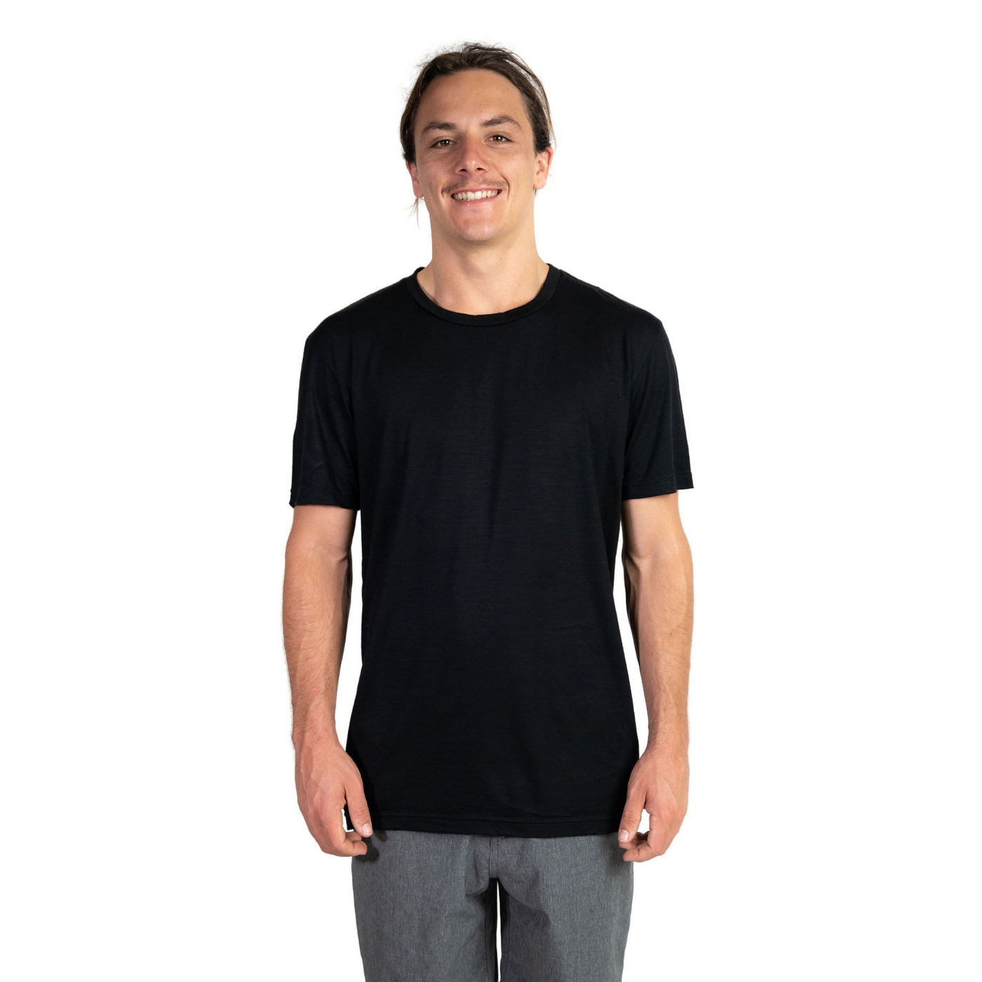 Front shot of Ottie Merino men's black short sleeve merino wool t-shirt on 173cm model who is wearing a size medium