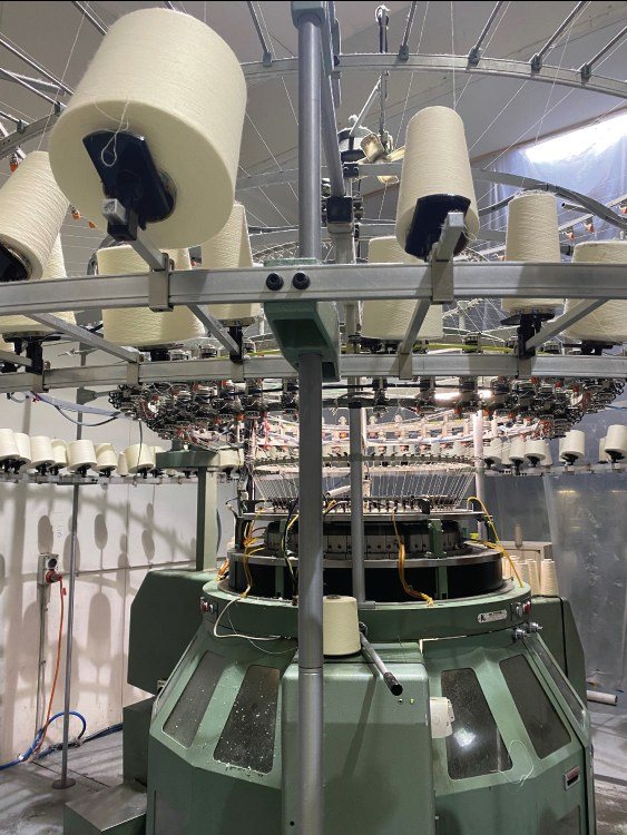 Circular knitting machine with cones of merino yarn
